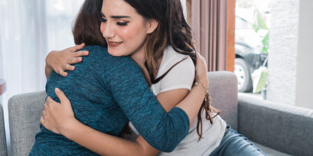 How-to-help-a-friend-in-debt-feature two women hugging