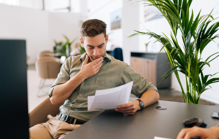 Myth-Busting-feature man reading document and scratching his chin