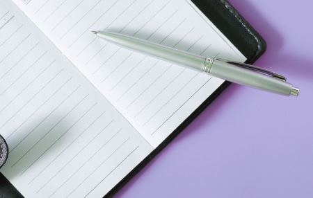 Diary-Feature open notebook against light purple background