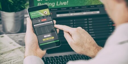 person placing a bet online on smartphone