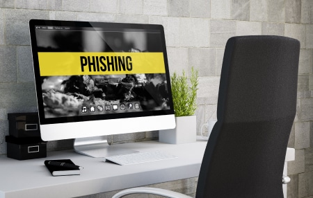 Debt-Management-Phishing_-How-to-Avoid-Being-Scammed-feature An image of an imac with the word "phishing" on the screen