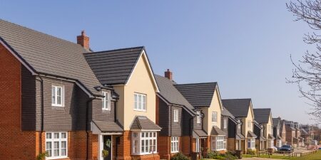 Does-Debt-Consolidation-Affect-Buying-a-Home-feature An image of houses on a new estate.
