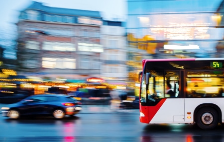Reduce the cost of commuting_ Practical tips for managing expenses feature Image of a bus and a car travelling down a main road