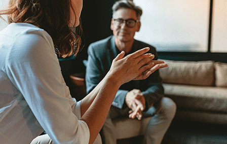 Talk Money Week (feature) Image of a man and a woman sitting on a sofa having a chat.