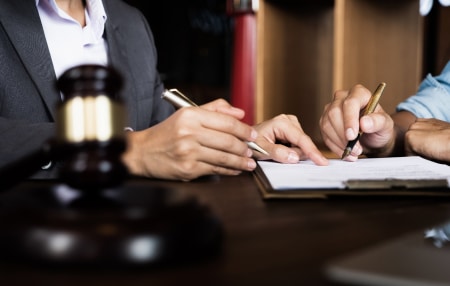 What happens if you don’t have a will_ feature Image of two people signing a piece of paper
