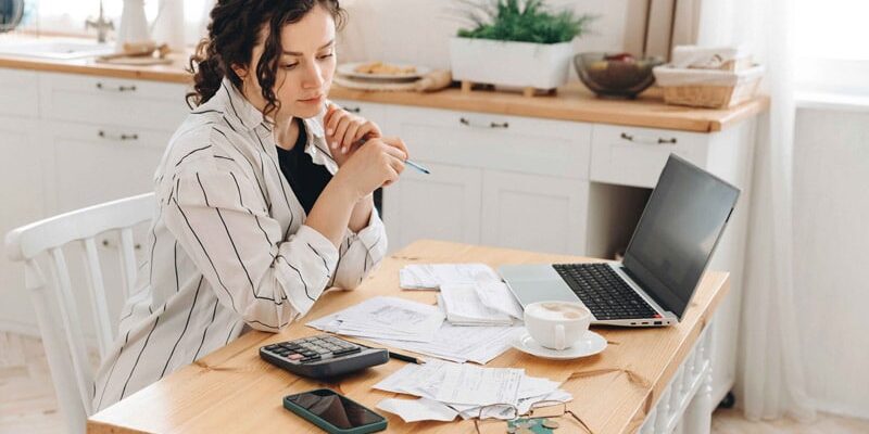 woman-reviewing-her-bills-2 Woman reviewing her bills