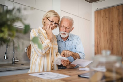 old couple reading a letter.