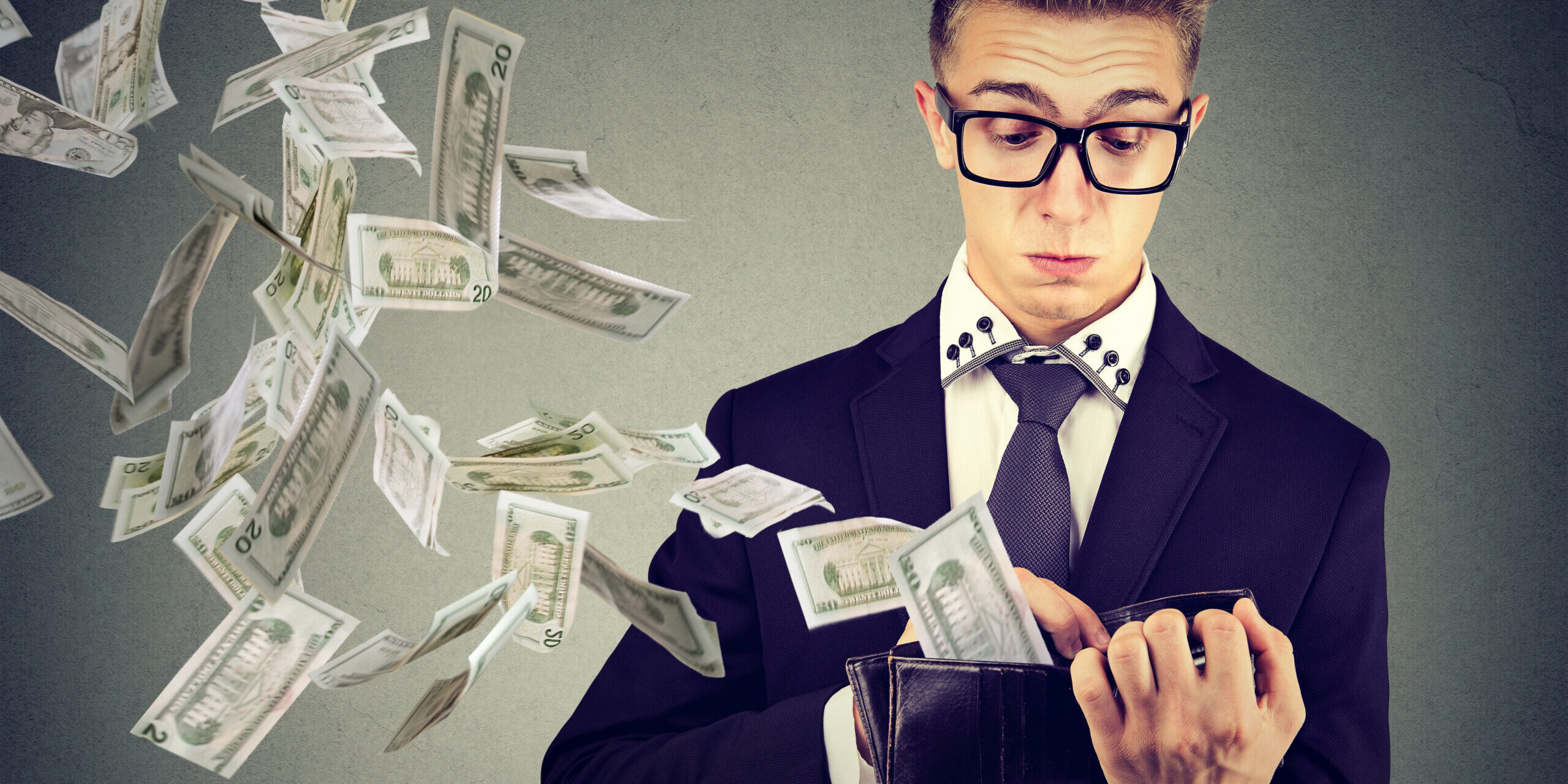 Man throwing money out of his wallet